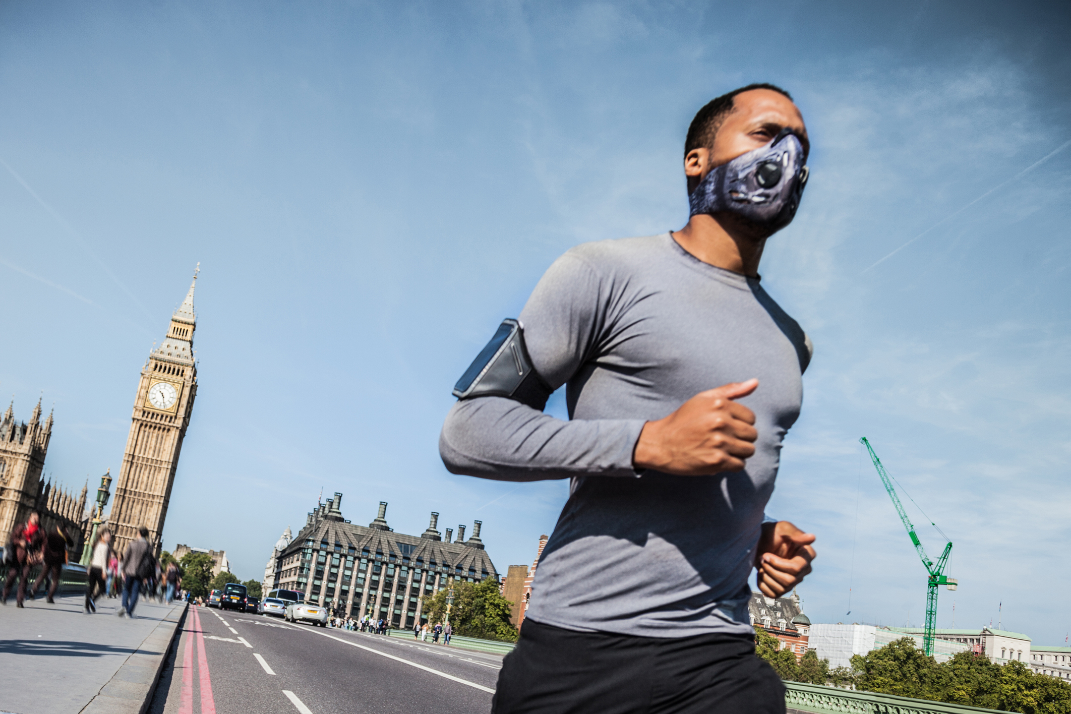 Man running across Westminster Bridge with mask on
